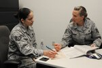Staff Sgt. Jennifer Swain, 359th Dental Squadron noncommissioned officer in charge of preventative dentistry and volunteer tax consultant, assists Staff Sgt. Cynthia Perez, 902nd Mission Support Group judge advocate, on her taxes at the new tax center Jan. 21. (U.S. Air Force photo/Amn Alexis Siekert)
