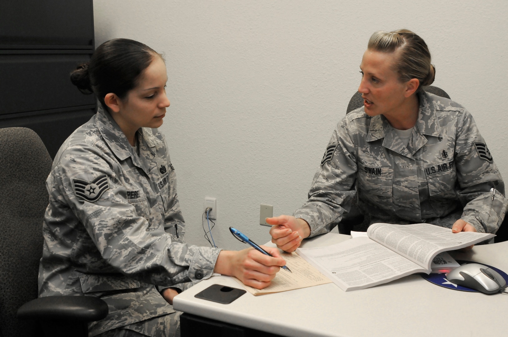 Staff Sgt. Jennifer Swain, 359th Dental Squadron noncommissioned officer in charge of preventative dentistry and volunteer tax consultant, assists Staff Sgt. Cynthia Perez, 902nd Mission Support Group judge advocate, on her taxes at the new tax center Jan. 21. (U.S. Air Force photo/Amn Alexis Siekert)