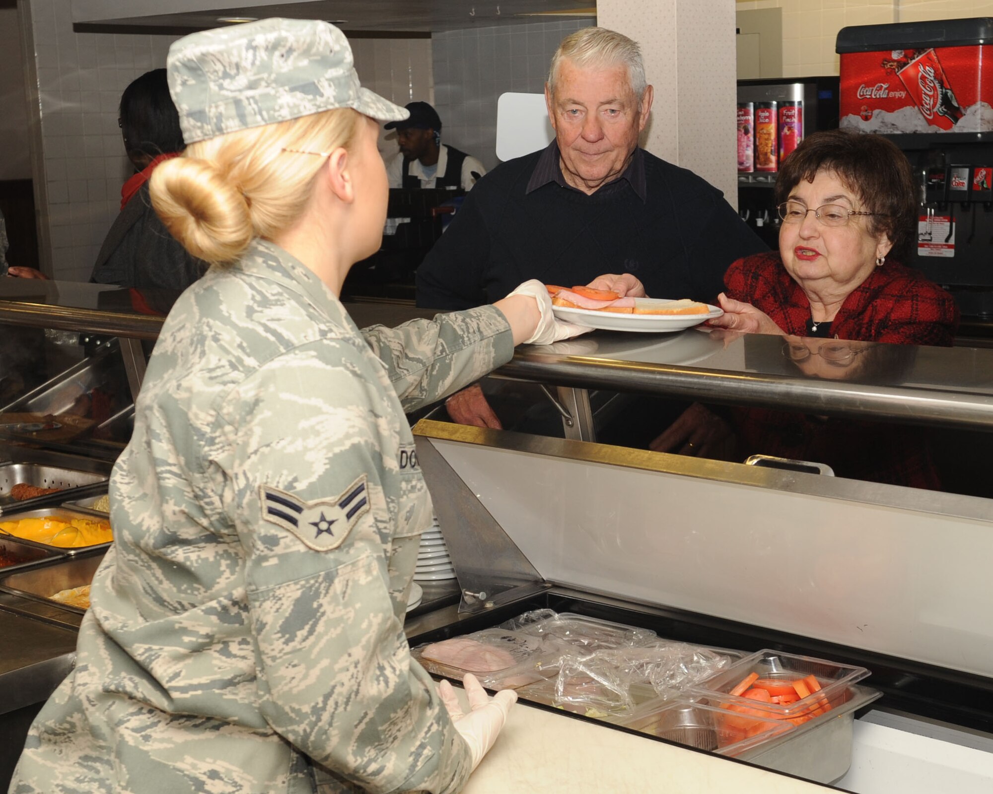 Selma Gaylor, wife of Chief Master Sergeant of the Air Force #5 Robert Gaylor (left), receives her lunch from Airman 1st Class Kayla Dordell, 2nd Force Support Squadron, at the Red River Dining Facility on Barksdale Air Force Base, La., Jan 21. Chief Gaylor spoke to Barksdale Airman at the Stripes Club, the dining facility, Airmen Leadership School and the First Term Airman's Center before speaking at the Chief Recognition Ceremony. (U.S. Air Force photo/Airman 1st Class Sean Martin)(Released)