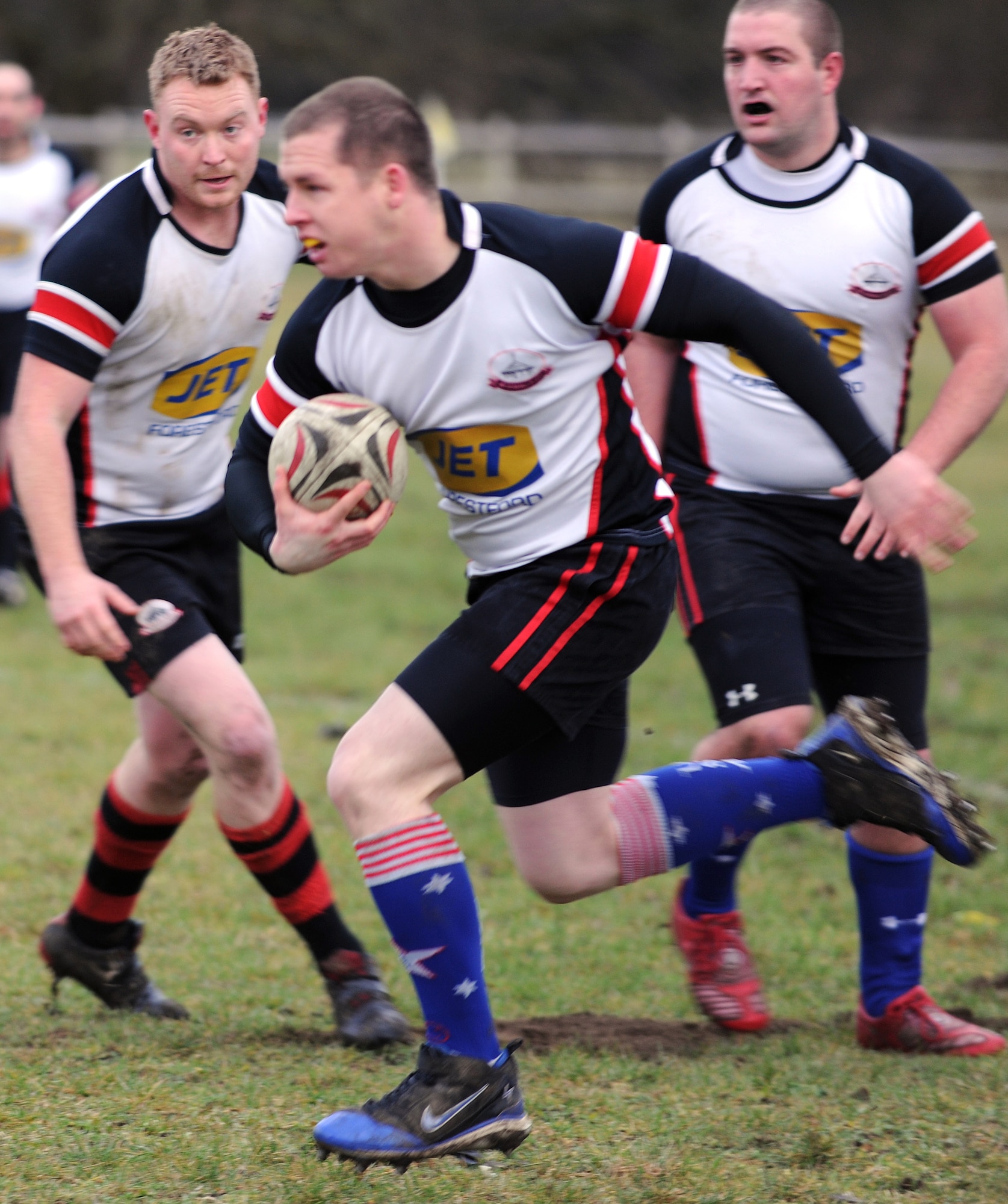 RAF MILDENHALL, England -- Scott Ricketts, 100th Civil Engineer Squadron structural journeyman, runs the ball during a game against Felixstowe RUFC at Jenner's Field in Holywell Row Jan. 22, 2011.  The Mildenhall RUFC is made up of British and American players from the local area. (U.S. Air Force photo/Senior Airman Tabitha M. Lee) 