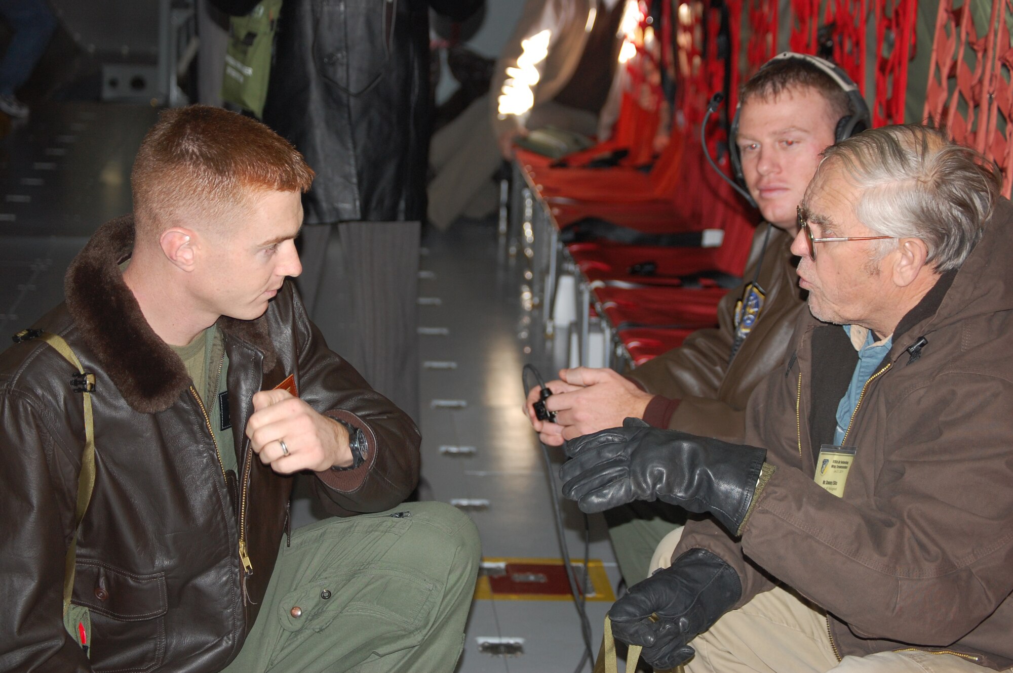 Marine Capt. Dan Evans (left), talks with 911th pilot Capt. Matt Carpenter and a civic leader during an orientation flight on Jan. 21. (USAF photo by Maj. Shannon Mann, 916ARW/PA)