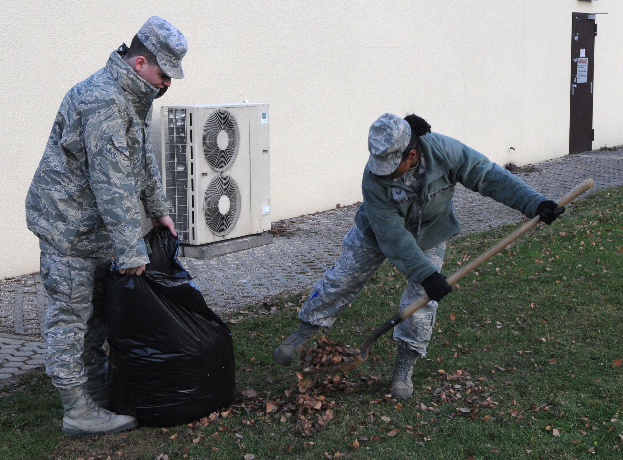 SPANGDAHLEM AIR BASE, Germany – Airman 1st Class Evan Holme, 52nd Communications Squadron cyber operations technician, and Staff Sgt. Norma Cruz-Roland, 52nd CS operations controller, rake and pick up leaves outside the network control center Jan. 21. The 52nd Fighter Wing held a base-wide cleanup in preparation for the Installation Excellence Award team’s arrival Jan. 24. Spangdahlem Air Base is competing against Travis Air Force Base, Calif., for the IEA. (U.S. Air Force photo/Airman 1st Class Matthew B. Fredericks)