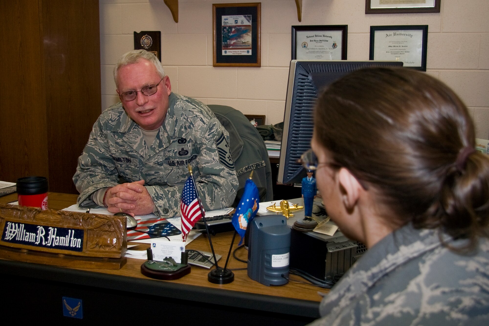GRISSOM AIR RESERVE BASE, Ind. -- Senior Master Sgt. William Hamilton, 434th Security Forces Squadron first sergeant, talks with a 434th SFS Airmen in his office during the January unit training assembly. Sergeant Hamilton was recently named the 434th Air Refueling Wing first sergeant of the year for 2010. Some of the first sergeant's most notable achievements in 2010 came while he was deployed to Afghanistan with the 434th Civil Engineers Squadron. (U.S. Air Force photo/Tech. Sgt. Mark R. W. Orders-Woempner)