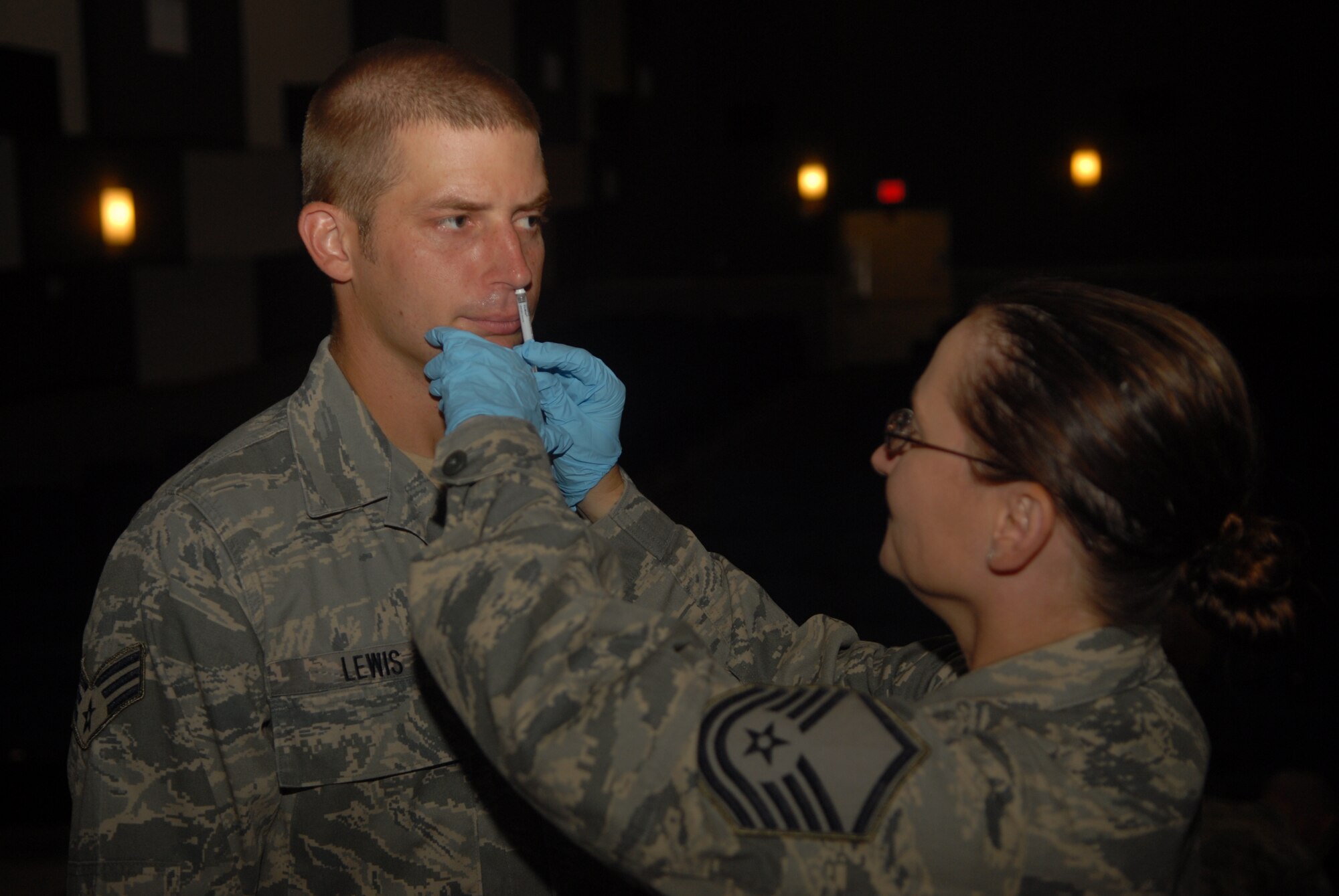 KUNSAN AIR BASE, Republic of Korea -- Master Sgt. Kelly Butterfuss, 8th Medical Group clinical medicine flight chief, administers the FluMist vaccine to an Airman here Sept. 3, 2010. The vaccine is mandatory for all active duty, Department of Defense contractors and appropriated funds employees and offers the best chance to protect people against the flu. (U.S. Air Force photo/Senior Airman Ciara Wymbs) 
