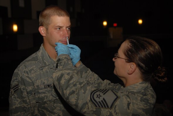 KUNSAN AIR BASE, Republic of Korea -- Master Sgt. Kelly Butterfuss, 8th Medical Group clinical medicine flight chief, administers the FluMist vaccine to an Airman here Sept. 3, 2010. The vaccine is mandatory for all active duty, Department of Defense contractors and appropriated funds employees and offers the best chance to protect people against the flu. (U.S. Air Force photo/Senior Airman Ciara Wymbs) 
