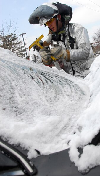 Senior Airman Josue Gonzalez, 51st Civil Engineer Squadron firefighter, cuts open the windshield of a vehicle during an accident scenario as part of Operational Readiness Exercise Beverly Bulldog 11-01 at Osan Air Base, Republic of Korea, Jan. 24. The scenario tested emergency responders' ability to operate in times of heightened readiness. (U.S. Air Force photo/Staff Sgt. Eunique Thomas)
