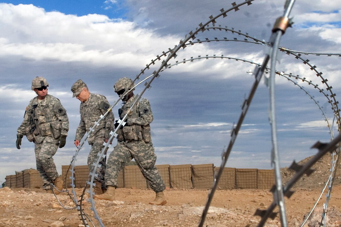 U.S. Army Brig. Gen. Robert "Abe" Abrams, left, commander of the National Training Center, leads Army Chief of Staff Gen. George W. Casey Jr. during his visit at the center on Fort Irwin, Calif., Jan. 22, 2011.