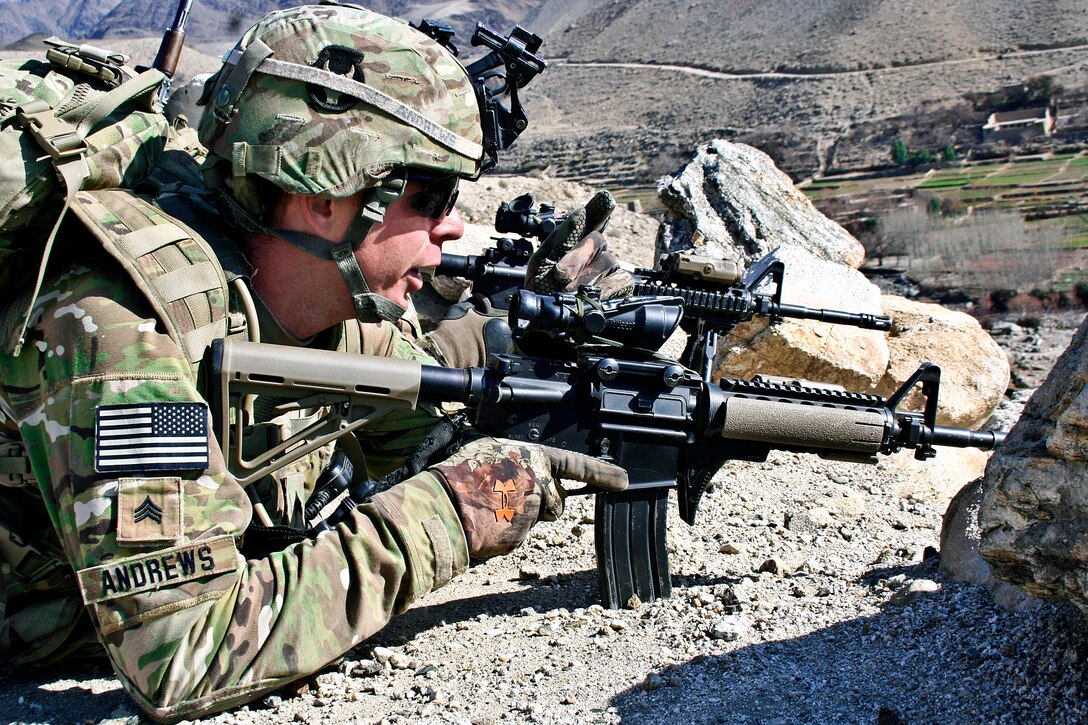 U.S. Army Sgt. Nick Andrews looks from a ridge into the town of Tupac in Nuristan province, Afghanistan, Jan. 21, 2010. Andrews is assigned to Company C, 1st Battalion, 133rd Infantry Regiment.