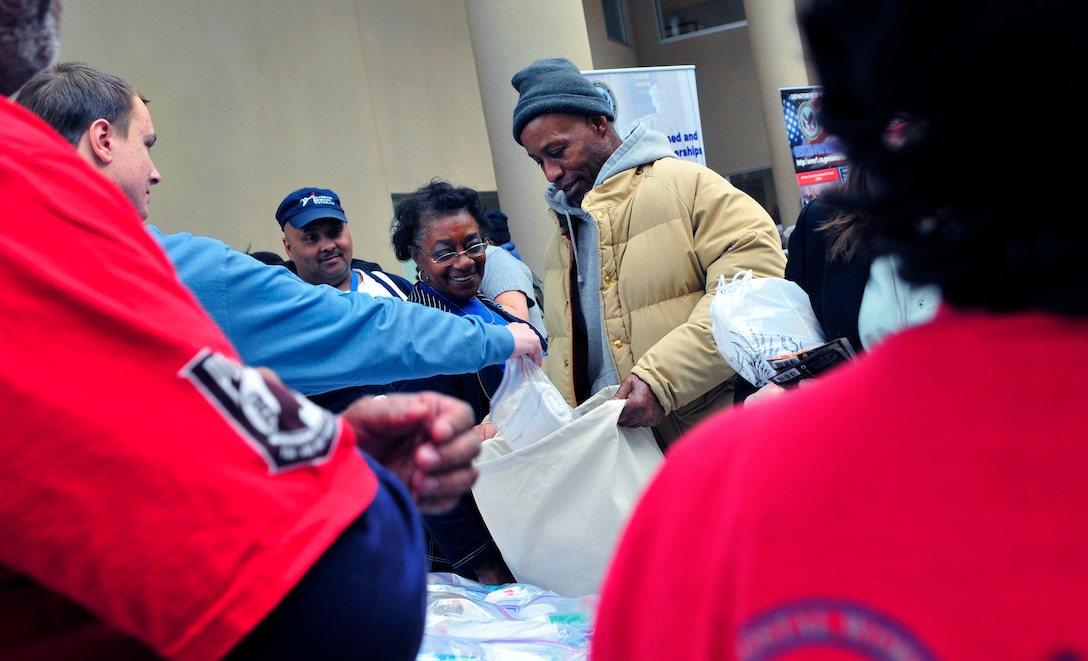 Michael Boatwright, a five-year Army veteran, receives toiletries from volunteers at the 15th annual Winterhaven Homeless Stand Down at the Veterans Affairs Medical Center in Washington, D.C., Jan. 22, 2011.
