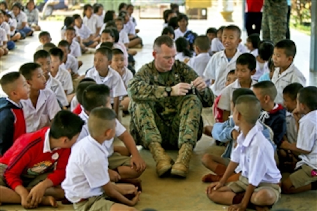 U.S. Marine Corps Capt. Alistair E. Howard interacts with children during exercise Cobra Gold at Baan Pong Wua School in Chantaburi province, Thailand, on Jan. 18, 2011.  Howard is a civil affairs officer assigned to the 3rd Marine Expeditionary Force.  Cobra Gold is the latest in a series of Thai-U.S. military exercises to ensure regional peace through a strategy of cooperative engagement.  