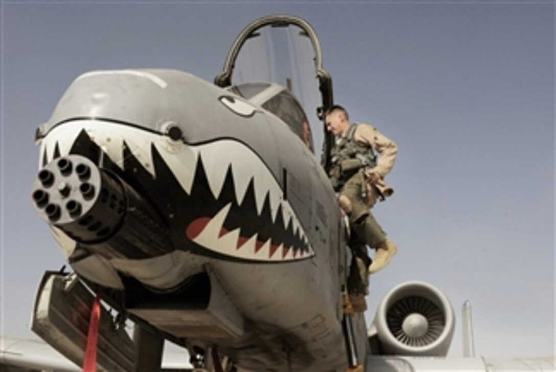 Maj. Loren Coulter exits an A-10C Thunderbolt II at Kandahar Airfield, Afghanistan, on Jan. 11, 2011.  The 75th Expeditionary Fighter Squadron moved their assets to the other side of the flight line, marking the first of many moves toward consolidating the 451st Air Expeditionary Wing's missions.  Coulter is an A-10 pilot assigned to the 75th Expeditionary Fighter Squadron.  