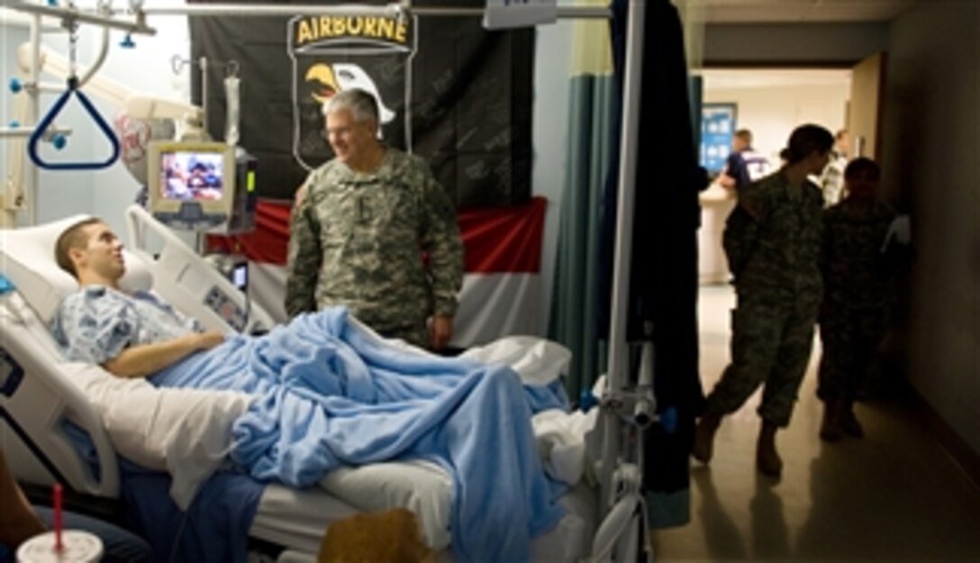 U.S. Army Chief of Staff Gen. George W. Casey Jr. talks with a soldier while medical staff stand by at Brooks Army Medical Center at Fort Sam Houston, Texas, on Jan. 21, 2011.  