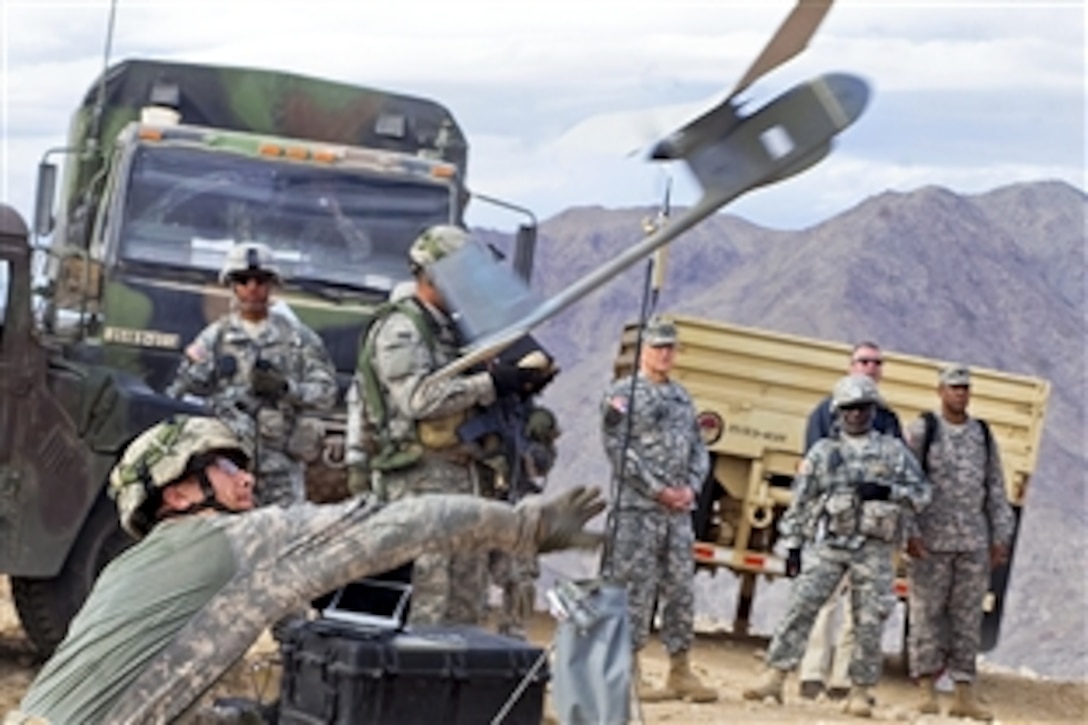 U.S. Army Cpl. Sean Connell launches a Raven, an unmanned aerial vehicle, while providing a demo to Army Chief of Staff Gen. George W. Casey Jr. at the National Training Center on Fort Irwin, Calif., Jan. 22, 2011. The center's mission is to provide  realistic, joint and combined arms training in multinational venues in a contemporary operating environment to assist commanders and soldiers by presenting current problem sets.