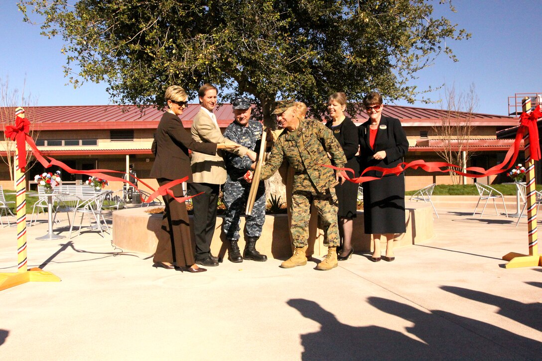 (From left to right) Susan Della-Cort, director, Marine and Family Support Program; Jeff Harper, president, Harper Construction Company; Navy Capt. Michael Williamson, officer-in-charge of construction, Marine Corps Installations West; Col. Nicholas F. Marano, commanding officer, Marine Corps Base Camp Pendleton; Yvonne Spencer (hidden), director, Child Development Center; Janet Sewell, family care branch manager, Camp Pendleton; Trisha Spencer, deputy director, Marine and Family Support Program; cut the ribbon in celebration of the opening of the new Deluz Child Development Center, Building 120111, Jan. 24. Since there is such a high demand for child care on base, Camp Pendleton put some of the 2009 American Recovery and Reinvestment Act funding to use by building the new facility to benefit base residents.