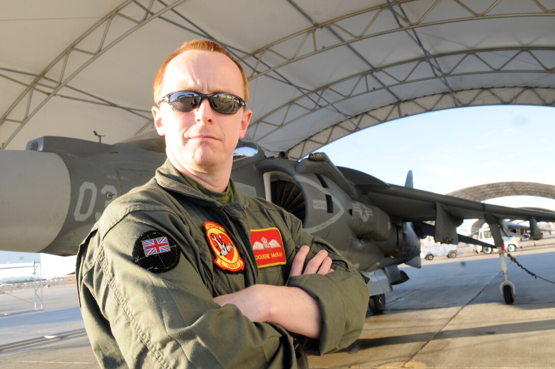 Flight Lieutenant Douglas McKay stands near an AV-8B Harrier on the flight line at the Marine Corps Air Station in Yuma, Ariz., Jan. 24, 2011. McKay is the last British exchange Harrier pilot left in the U.S., and after his scheduled departure from America this summer, the program will end. "I love flying Harriers," said McKay. "Yuma's one of the best places to do it, all the wide open space and one of the biggest aviation ordnance ranges that I know of. It's wonderful; I'm going to miss it."