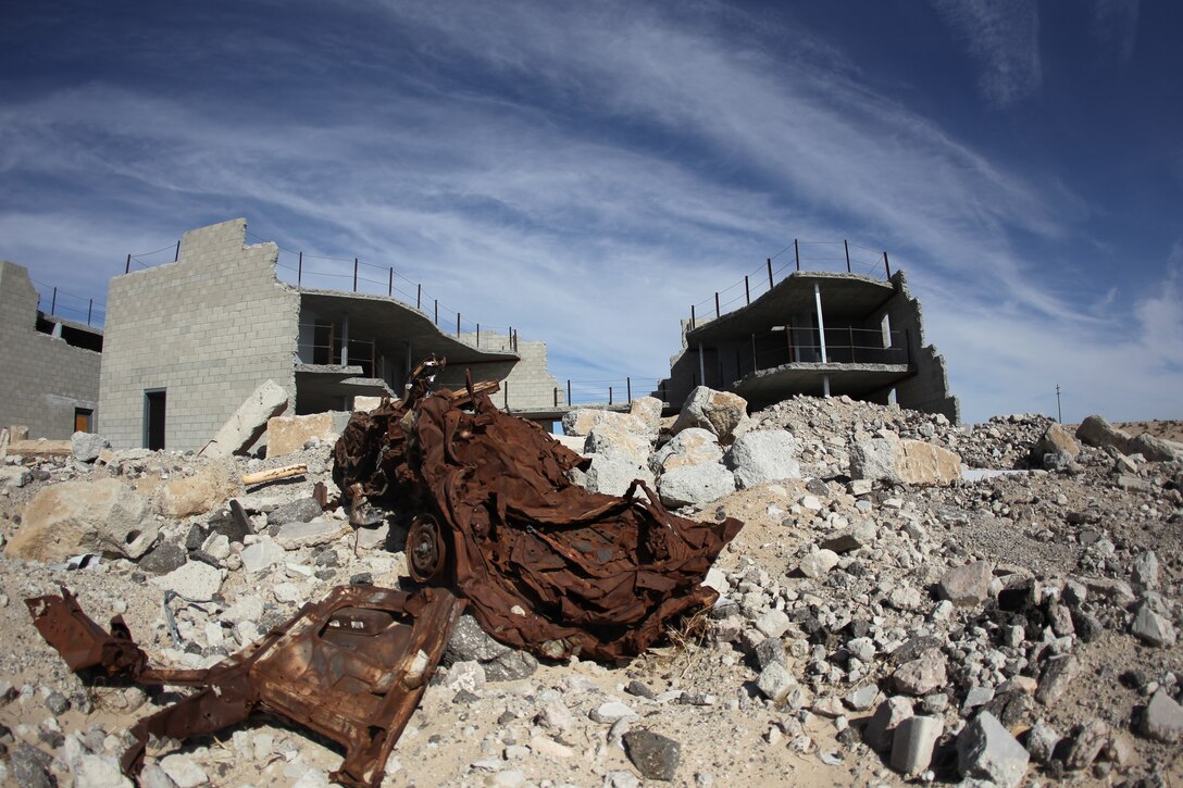 Mangled vehicles and building rubble set a realistic scene the 274-acre Combined Arms Military Operations on Urban Terrain range complex at Range 220. The $170 million project, unveiled Jan. 25, 2011, encompasses 274 acres of training space organized into seven separate mock city districts.  Marines will use the 1,560 building range, roughly equivalent in size to downtown San Diego, to practice and refine the complex and dangerous tactics they will use while deployed to urban settings around the world. The layout of the city confronts Marines with a full range of tactical challenges from humanitarian relief efforts to peacekeeping and law enforcement to direct combat, all of which can take place in a tightly compressed “real world” timeline known to Marines as the “three block war.” The new range is the largest of its kind in the Marine Corps.