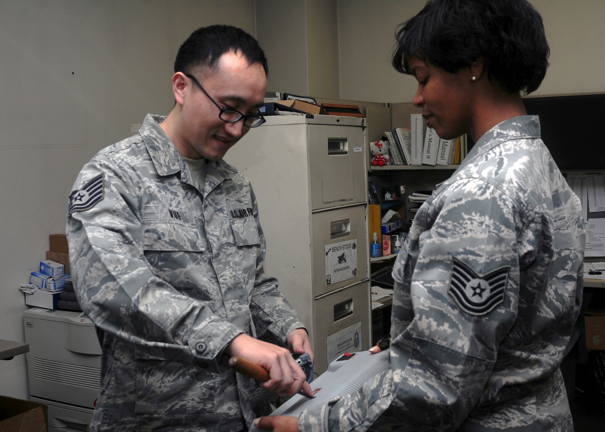 YOKOTA AIR BASE, Japan -- Tech. Sgt. Ya Vue (left) and Tech. Sgt. Carole Lampley, members of the 374th Logistics Readiness Squadron equipment accountability element, utilize the new asset marking and tracking system to label a piece of inventory equipment here Jan. 25. The new equipment labeling system is being implemented Air Force wide. (U.S. Air Force Photo/Airman 1st Class Krystal Garrett) 
