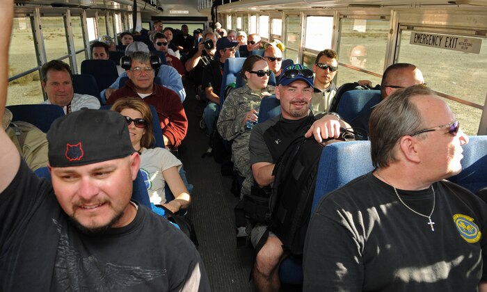 NELLIS AIR FORCE BASE, Nev. -- Photographers ride a bus from the flightline after taking photos of aircraft deployed in support of Red Flag 11-2 during an organized media day Jan. 25. The 99th Air Base Wing Public Affairs office escorted more than 40 aviation photographers from across North America and Europe to take photos for various publications. Throughout the combined, combat training exercise the office will arrange about 13 media visits for local and national news agencies to tell the Red Flag story. (U.S. Air Force photo/Staff Sgt. Benjamin Wilson)