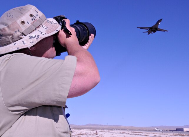 NELLIS AIR FORCE BASE, Nev. -- Jim Mumaw takes photos of a B-1Lancer deployed in support of Red Flag 11-2 during an organized media day on the flightline Jan. 25. The 99th Air Base Wing Public Affairs office escorted more than 40 aviation photographers from across North America and Europe to take photos for various publications. Throughout the combined, combat training exercise the office will arrange about 13 media visits for local and national news agencies to tell the Red Flag story. (U.S. Air Force photo/Staff Sgt. Benjamin Wilson)