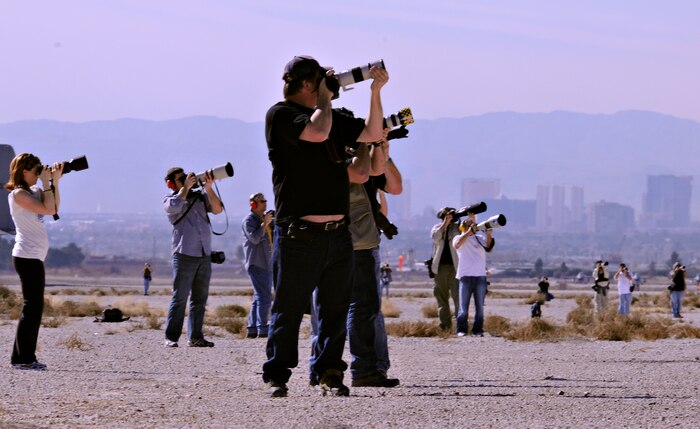 NELLIS AIR FORCE BASE, Nev. -- Photographers take photos of aircraft deployed in support of Red Flag 11-2 during an organized media day on the flightline Jan. 25. The 99th Air Base Wing Public Affairs office escorted more than 40 aviation photographers from across North America and Europe to take photos for various publications. Throughout the combined, combat training exercise the office will arrange about 13 media visits for local and national news agencies to tell the Red Flag story. (U.S. Air Force photo/Staff Sgt. Benjamin Wilson)