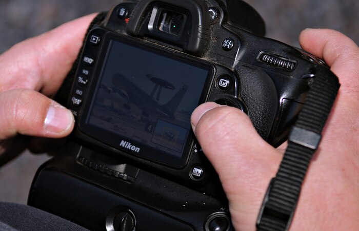 NELLIS AIR FORCE BASE, Nev. -- A photographer checks his image of an E-3 Sentry deployed in support of Red Flag 11-2 during an organized media day on the flightline Jan. 25. The 99th Air Base Wing Public Affairs office escorted more than 40 aviation photographers from across North America and Europe to take photos for various publications. Throughout the combined, combat training exercise the office will arrange about 13 media visits for local and national news agencies to tell the Red Flag story. (U.S. Air Force photo/Staff Sgt. Benjamin Wilson)