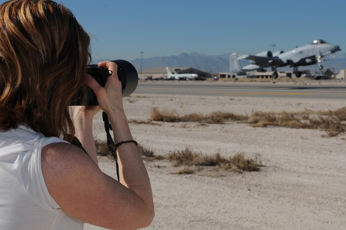 NELLIS AIR FORCE BASE, Nev. -- Elizabeth Stetor takes photos of an A-10 Thunderbolt II deployed in support of Red Flag 11-2 during an organized media day on the flightline Jan. 25. The 99th Air Base Wing Public Affairs office escorted more than 40 aviation photographers from across North America and Europe to take photos for various publications. Throughout the combined, combat training exercise the office will arrange about 13 media visits for local and national news agencies to tell the Red Flag story. (U.S. Air Force photo/Staff Sgt. Benjamin Wilson)