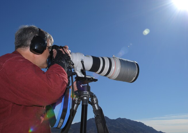 NELLIS AIR FORCE BASE, Nev. -- Peter Mancus takes photos of aircraft deployed in support of Red Flag 11-2 during an organized media day on the flightline Jan. 25. The 99th Air Base Wing Public Affairs office escorted more than 40 aviation photographers from across North America and Europe to take photos for various publications. Throughout the combined, combat training exercise the office will arrange about 13 media visits for local and national news agencies to tell the Red Flag story. (U.S. Air Force photo/Staff Sgt. Benjamin Wilson)