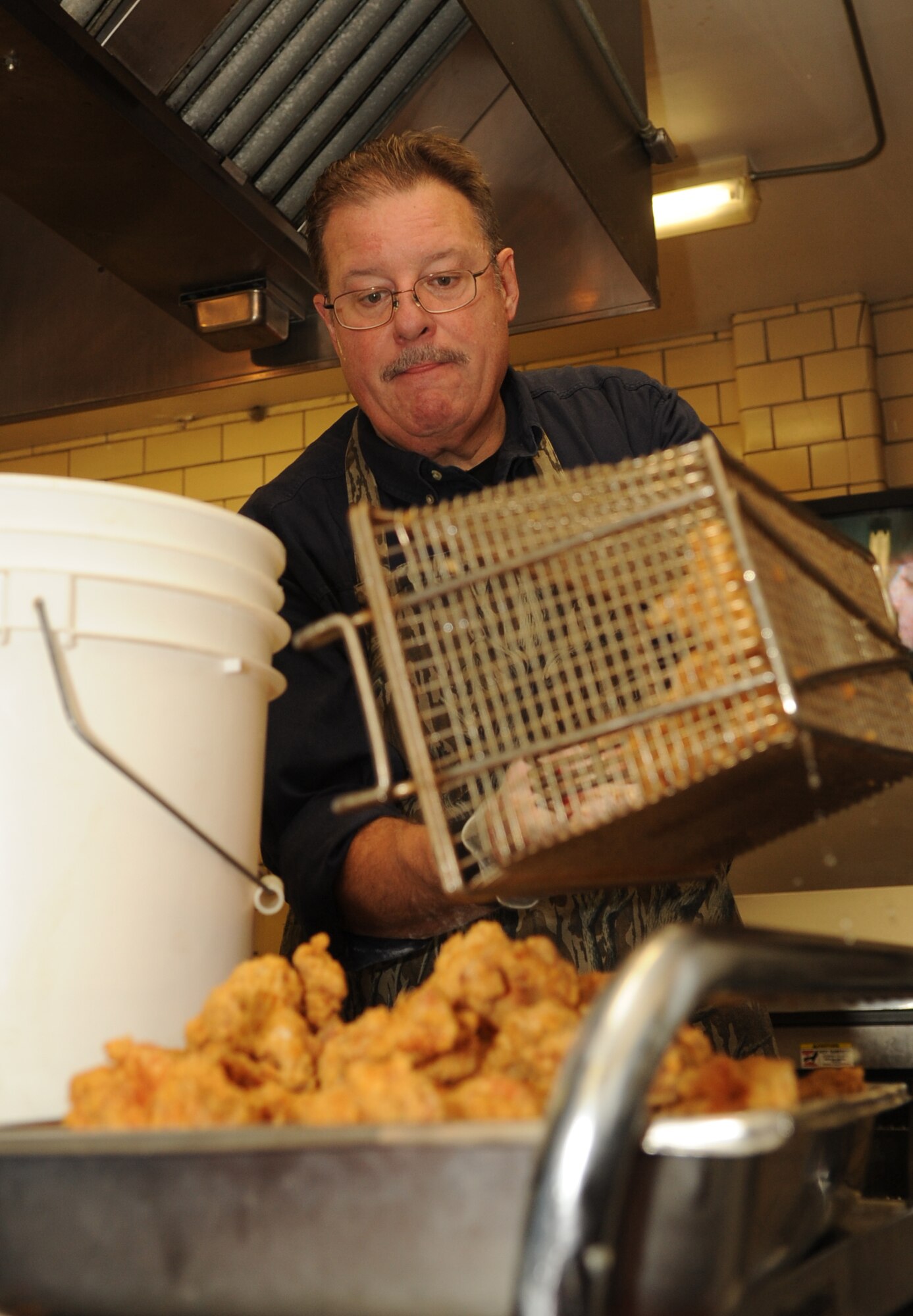 MINOT AIR FORCE BASE, N.D. – John MacMartin, president of the Minot Area Chamber of Commerce, pulls a batch of pheasant strips from the fryer at the 46th Annual Team Minot Sportsmen Feed held at the Jimmy Doolittle Center here Jan. 23. The annual event brings Minot’s Airmen and members of the local community together for food, fun and camaraderie. (U.S. Air Force photo/Tech. Sgt. Thomas Dow)
