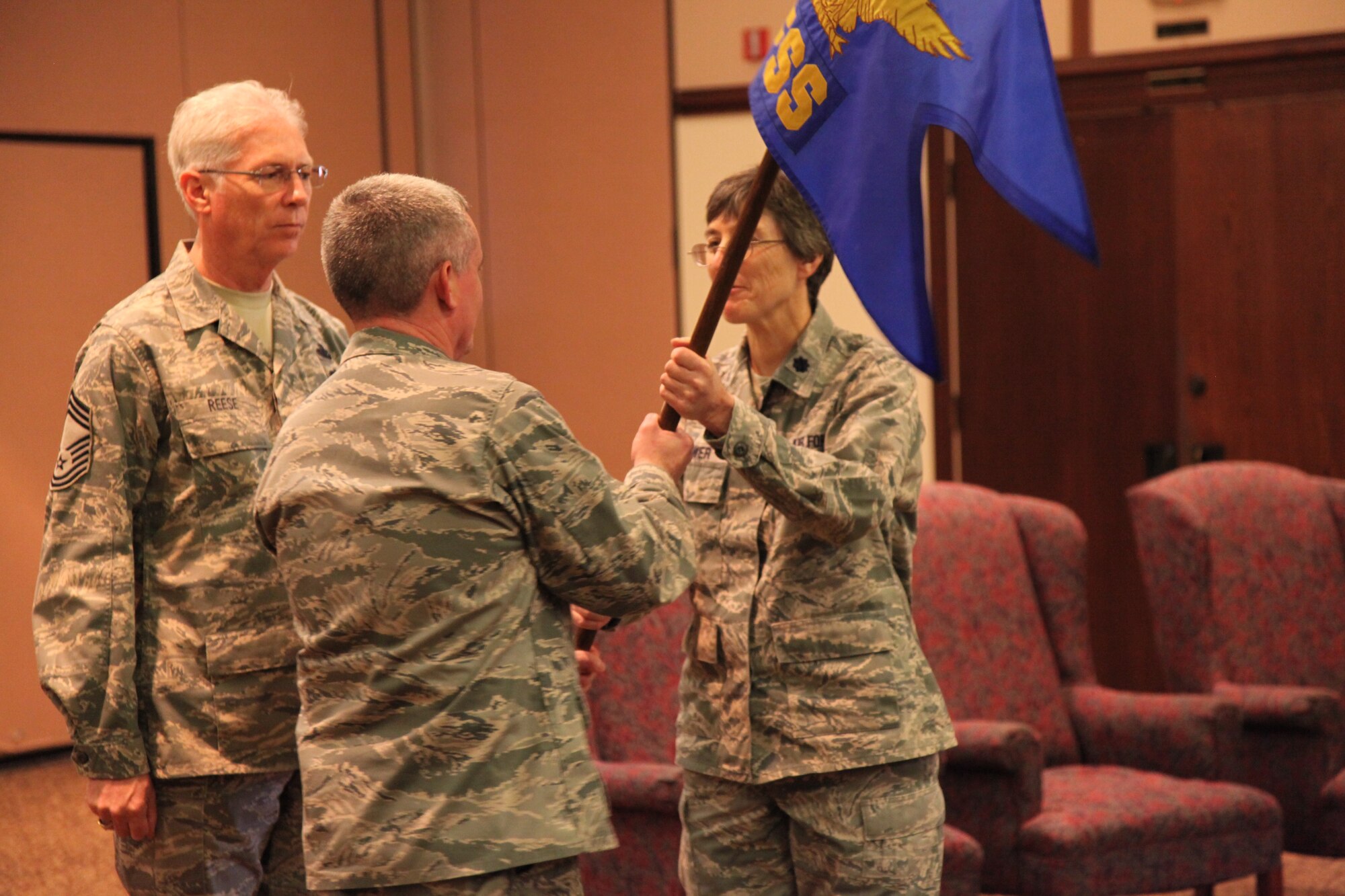 Col. John Trnka, 940th Wing commander presents the new 940th Force Support Squadron flag to Lt. Col. Patricia Brewer, 940th Mission Support Group commander during the 940th FSS activation ceremony, Jan. 9. The new 940th FSS squadron is part of an Air Force wide initiative to streamline both personnel and services functions into one organization. (U.S. Air Force photo/ Senior Airman Adam Hamar)