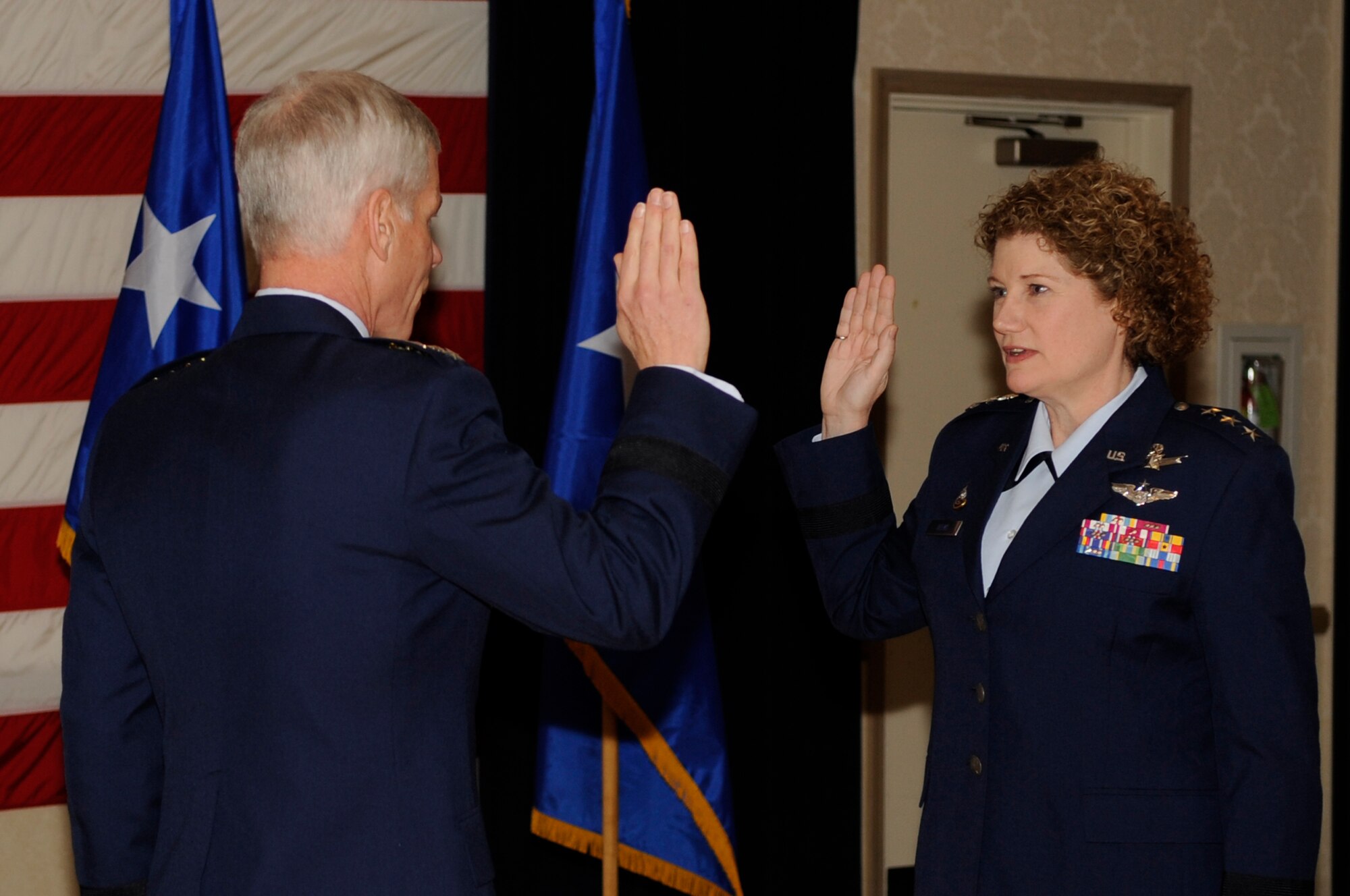 VANDENBERG AIR FORCE BASE, Calif. -- Gen. William Shelton, commander of Air Force Space Command, promotes Maj. Gen. Susan Helms to the rank of lieutenant general during a promotion ceremony here Jan. 21. Following her promotion ceremony, General Helms became the commander of the Joint Functional Component Command for Space and 14th Air Force, taking over for Lt. Gen. Larry James. (U.S. Air Force photo/Senior Airman Andrew Satran)
