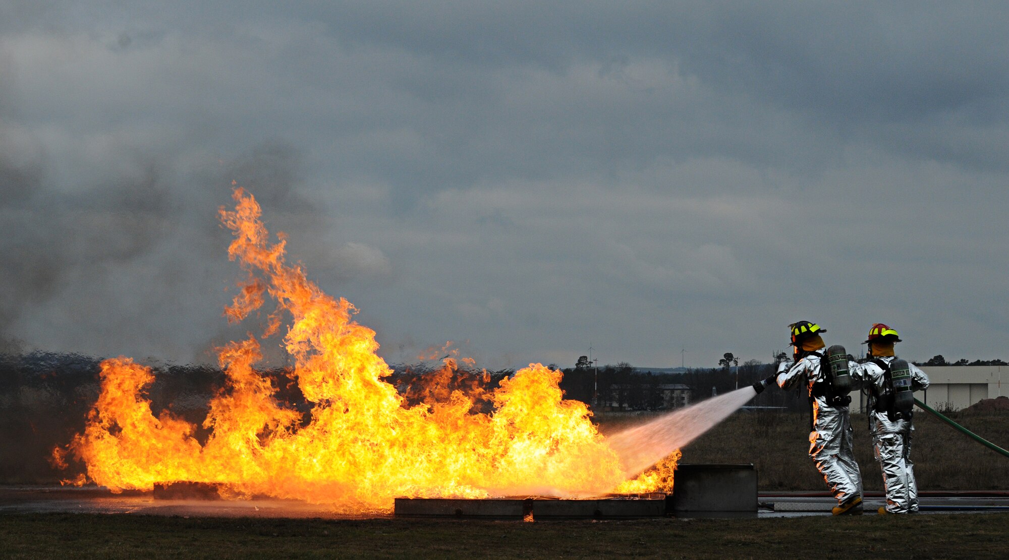 U.S. Army Soldiers from the 18th Combat Support Sustainment Regiment's 23rd Ordinance Company, battle a ground fire during Mobile Aircraft Firefighting Training, Ramstein Air Base, Germany, Jan. 21, 2011. The soldiers are on a three-week tour working side-by-side airmen from the 886th Civil Engineer Squadron to gain a better understanding on how Air Force firefighters operate. (U.S. Air Force photo by Staff Sgt. Nathan Lipscomb)