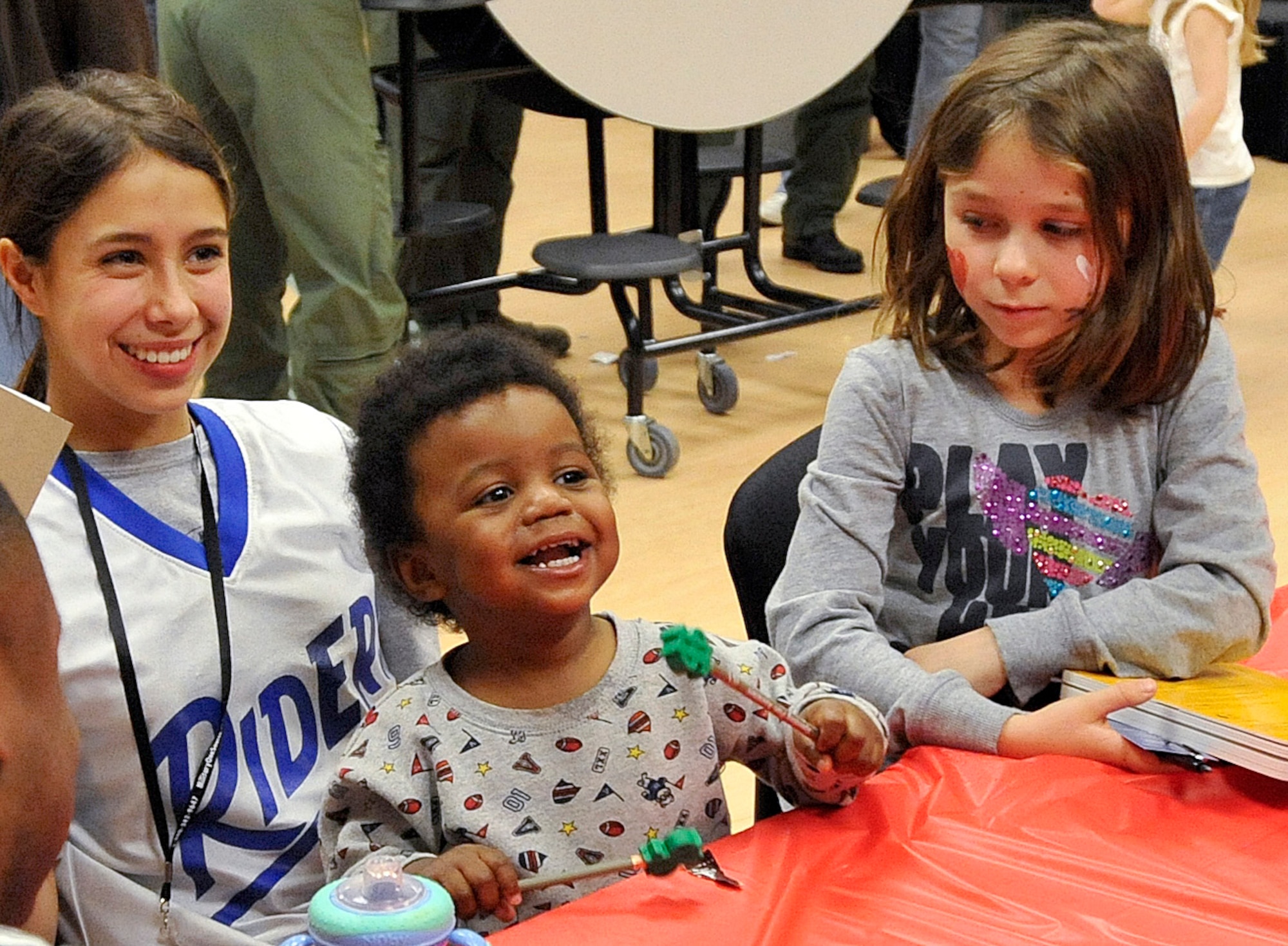 Carrie Weston (left), Demarkio Anderson and Domitila Weston spend time together at the youth center during the Deployed Family?s Dinner Jan. 20 organized by the 436th Operations Group. The dinner was hosted to support families of deployed servicemembers. ?We can?t make deployments any shorter, but we can make them easier on the families,? said Master Sgt. Erik Appeldoorn, C-17 loadmaster with 3rd Airlift Squadron. (U.S. Air Force photo by Airman 1st Class Samuel Taylor/Released)