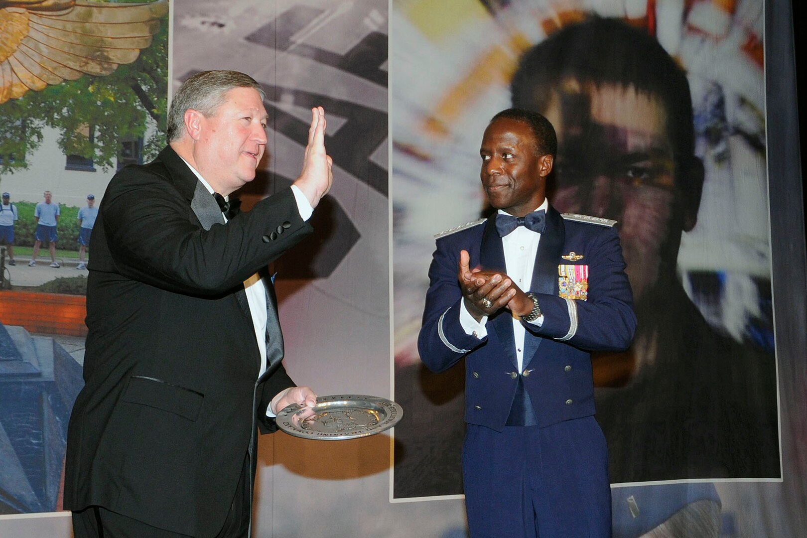 Secretary of the Air Force Michael Donley accepts an award from Gen. Edward Rice, Jr., Air Education and Training Command commander, Jan. 21 at the 2011 AETC Symposium Ball in San Antonio, Texas. Nearly a thousand Airmen from across the command gathered for the symposium and to hear Secratary Donley speak. (U.S. Air Force photo/by Don Lindsey) 