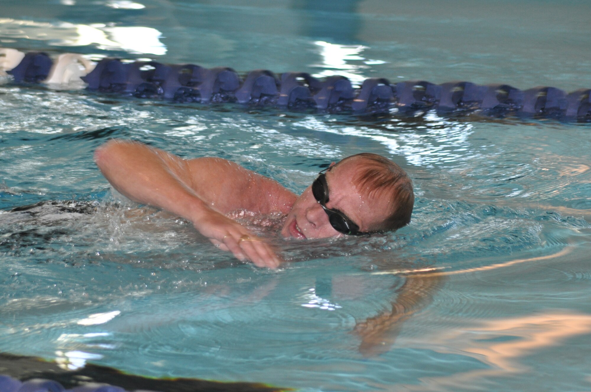 Senior Master Sgt. Stefan Henrich, 10th Air Force Surgeon General's medical readiness management NCOIC, swims laps during his lunch break at the base pool Dec. 14, 2010. To Sgt. Henrich, a swimmer since 5 years old, the sport not only helps him stay in shape, but also relaxes him. (Air Force photo/SrA Melissa Harvey)