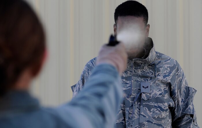U.S. Air Force Airmen with the 75th Security Forces Squadron rinse Oleoresin capsicum, or pepper spray, from their eyes during mandatory training for new security forces Airmen at Hill Air Force Base, Utah, Jan. 5, 2011. The spray produces tears and pain, and the full effects last 30 to 45 minutes. (U.S. Air Force photo by Airman 1st Class Allen Stokes/Released)

