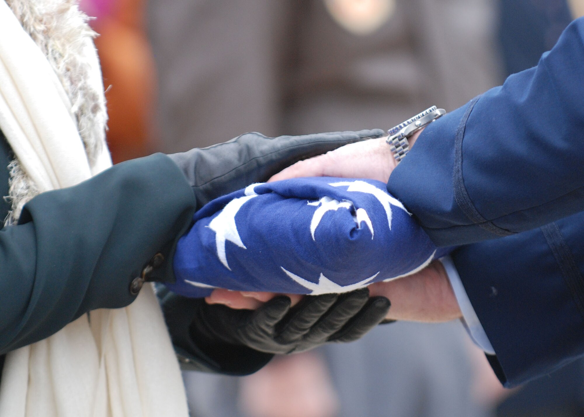 DALLAS— The American flag is handed off Jan. 14 during a funeral ceremony at the Dallas-Fort Worth National Cemetery. More than 41 years ago, Col. James Dennany, 34, of Kalamazoo, Mich., and Maj. Robert Tucci, 27, of Detroit, were flying an F-4D escorting an AC-130 gunship on a night strike mission during the Vietnam War, when they were shot down by anti-aircraft gunfire. A search was conducted afterward, but revealed nothing. No other search was initiated due to heavy anti-aircraft fire in the area. In 1999, officials in Laos turned over crew-related equipment, two .38 caliber pistols and human remains. Scientists from the Joint POW/MIA Accounting Command used circumstantial evidence and forensic tools to identify the remains. Col. Dennany and Maj. Tucci were laid to rest Jan. 14 at the Dallas-Fort Worth National Cemetery. According to the Defense Prisoner of War/Missing Personnel Office, there are still 1,713 U.S. servicemen still unaccounted for from the Vietnam War. (U.S Air Force photo/ Airman 1st Class Shannon Hall)