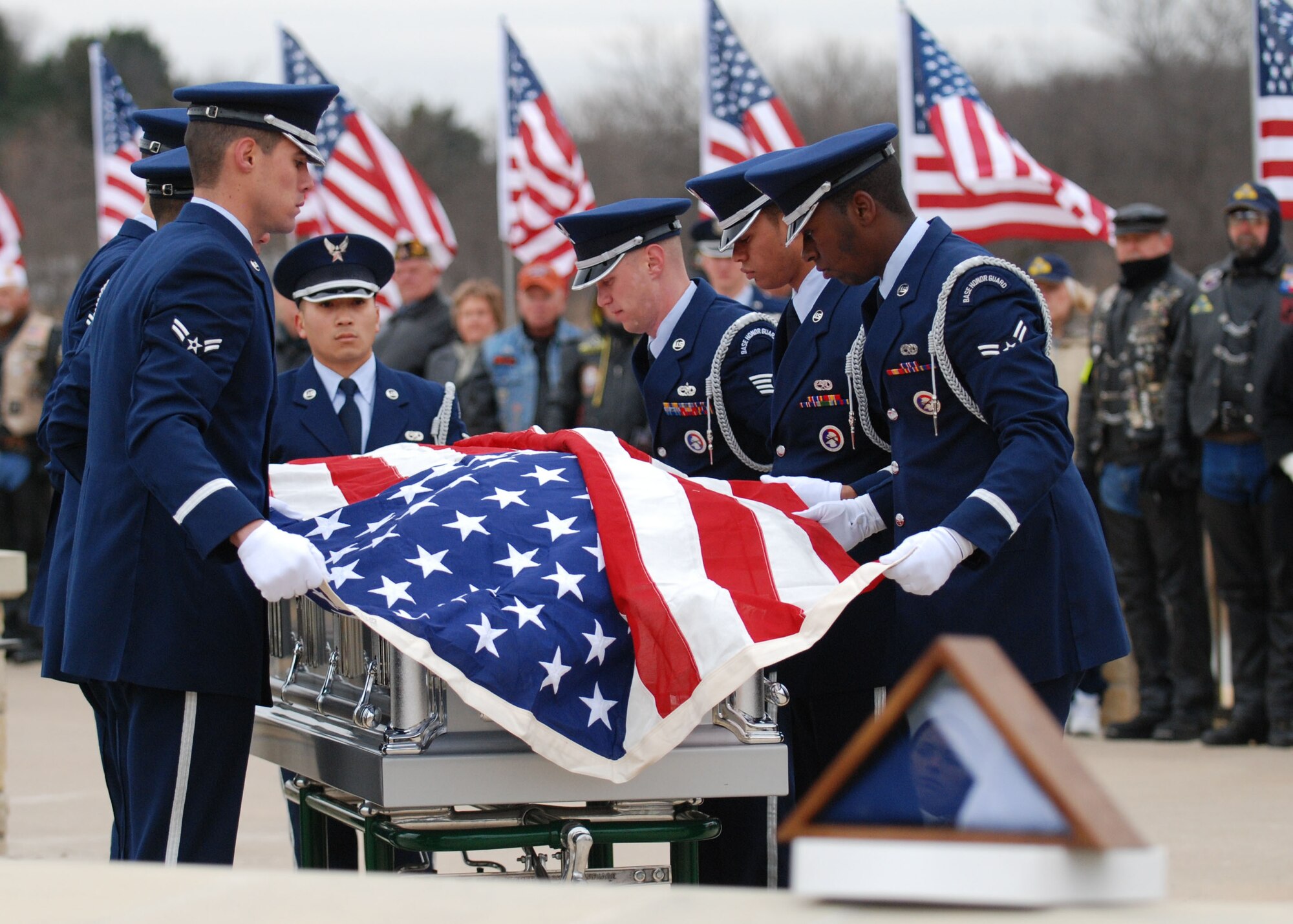 DALLAS—Honor Guard members from Dyess Air Force Base, Texas, drape the flag over a casket Jan. 14 during a funeral ceremony at the Dallas-Fort Worth National Cemetery. More than 41 years ago, Col. James Dennany, 34, of Kalamazoo, Mich., and Maj. Robert Tucci, 27, of Detroit, were flying an F-4D escorting an AC-130 gunship on a night strike mission during the Vietnam War, when they were shot down by anti-aircraft gunfire. A search was conducted afterward, but revealed nothing. No other search was initiated due to heavy anti-aircraft fire in the area. In 1999, officials in Laos turned over crew-related equipment, two .38 caliber pistols and human remains. Scientists from the Joint POW/MIA Accounting Command used circumstantial evidence and forensic tools to identify the remains. Col. Dennany and Maj. Tucci were laid to rest Jan. 14 at the Dallas-Fort Worth National Cemetery. According to the Defense Prisoner of War/Missing Personnel Office, there are still 1,713 U.S. servicemen still unaccounted for from the Vietnam War. (U.S Air Force photo/ Airman 1st Class Shannon Hall)