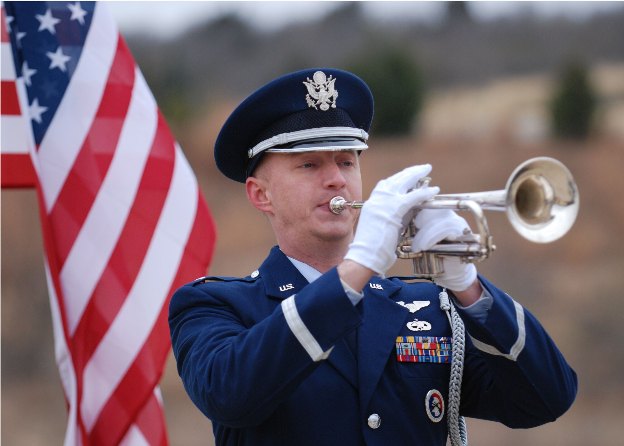 DALLAS—1st Lt. Adam Baker, 28th Bomb Squadron, plays reveille Jan. 14 during a funeral ceremony at the Dallas-Fort Worth National Cemetery.  More than 41 years ago, Col. James Dennany, 34, of Kalamazoo, Mich., and Maj. Robert Tucci, 27, of Detroit, were flying an F-4D escorting an AC-130 gunship on a night strike mission during the Vietnam War, when they were shot down by anti-aircraft gunfire. A search was conducted afterward, but revealed nothing. No other search was initiated due to heavy anti-aircraft fire in the area. In 1999, officials in Laos turned over crew-related equipment, two .38 caliber pistols and human remains. Scientists from the Joint POW/MIA Accounting Command used circumstantial evidence and forensic tools to identify the remains. Col. Dennany and Maj. Tucci were laid to rest Jan. 14 at the Dallas-Fort Worth National Cemetery. According to the Defense Prisoner of War/Missing Personnel Office, there are still 1,713 U.S. servicemen still unaccounted for from the Vietnam War. (U.S Air Force photo/ Airman 1st Class Shannon Hall)