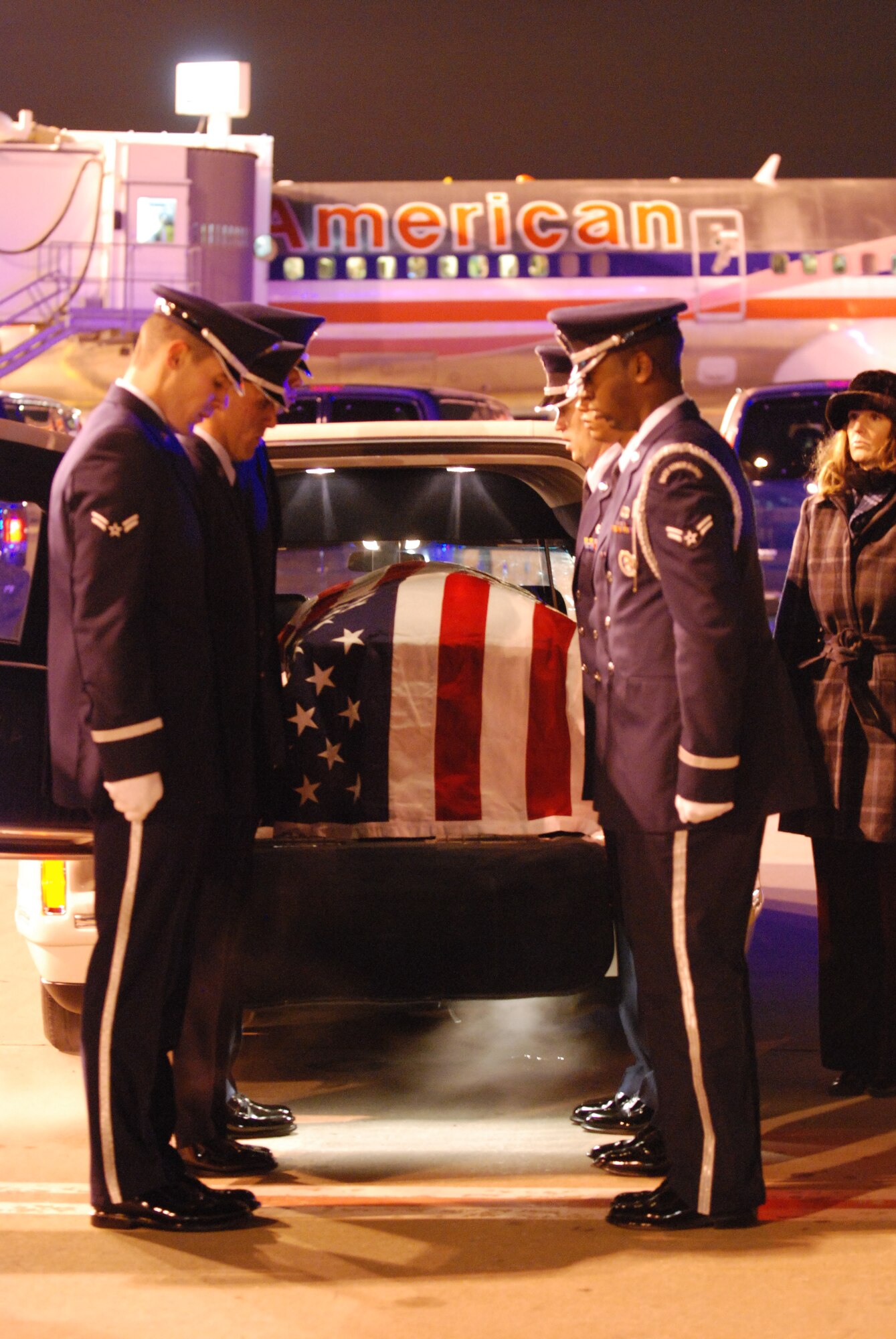 DALLAS—Honor Guard members from Dyess Air Force Base, Texas, stand at attention Jan. 13 after placing a casket in a hearse at the Dallas/Ft. Worth International Airport. More than 41 years ago, Col. James Dennany, 34, of Kalamazoo, Mich., and Maj. Robert Tucci, 27, of Detroit, were flying an F-4D escorting an AC-130 gunship on a night strike mission during the Vietnam War, when they were shot down by anti-aircraft gunfire. A search was conducted afterward, but revealed nothing. No other search was initiated due to heavy anti-aircraft fire in the area. In 1999, officials in Laos turned over crew-related equipment, two .38 caliber pistols and human remains. Scientists from the Joint POW/MIA Accounting Command used circumstantial evidence and forensic tools to identify the remains. Col. Dennany and Maj. Tucci were laid to rest Jan. 14 at the Dallas-Fort Worth National Cemetery. According to the Defense Prisoner of War/Missing Personnel Office, there are still 1,713 U.S. servicemen still unaccounted for from the Vietnam War. (U.S Air Force photo/ Airman 1st Class Shannon Hall)