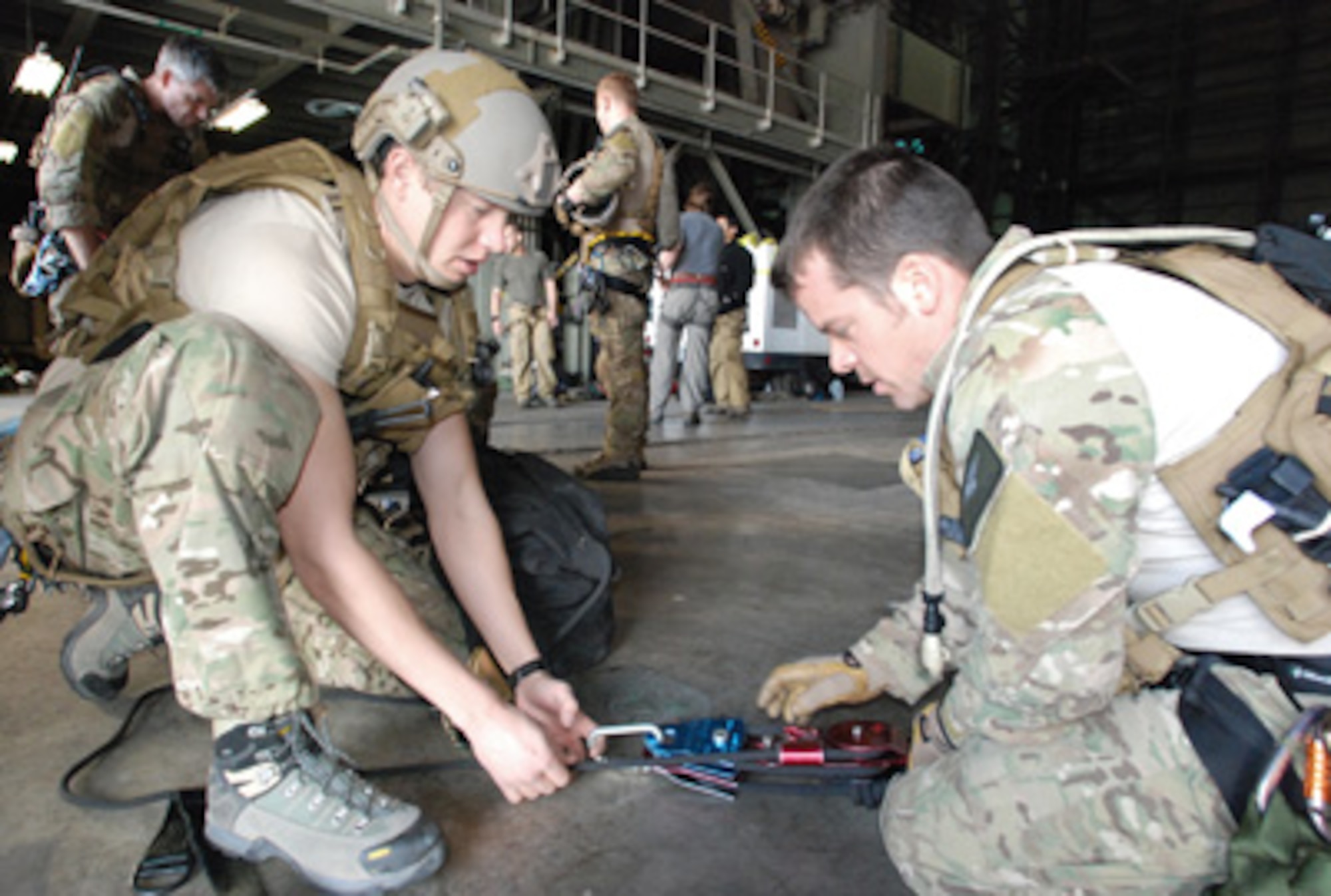 Pararescuemen Senior Airman Eric Humphrey (left) and Master Sgt. Joe Traska prepare their ropes and pulleys for rescue training Jan 20, 2011, at Cape Canaveral Air Force Station, Fla. The training is a high-angle, high-altitude and confined space rescue refresher for the PJs and combat rescue officers. Airman Humphrey and Sergeant Traska are with the Air Force Reserve Command’s 920th Rescue Wing.  (U.S. Air Force photo/Staff Sgt. Leslie Kraushaar)
