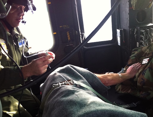 Maj. (Dr.) Mark Robinson, from Fairchild Air Force Base, Wash., treats Mr. Argyle Mydland during a rescue Jan. 22, 2010, near Lake Pend Oreille, Idaho. A helicopter crew from the 36th Rescue Flight was sent to the area to airlift Mr. Mydland to Sacred Heart Medical Center in Washington. Dr. Robinson is a flight surgeon with the 336th Training Support Squadron. (Courtesy photo) 
