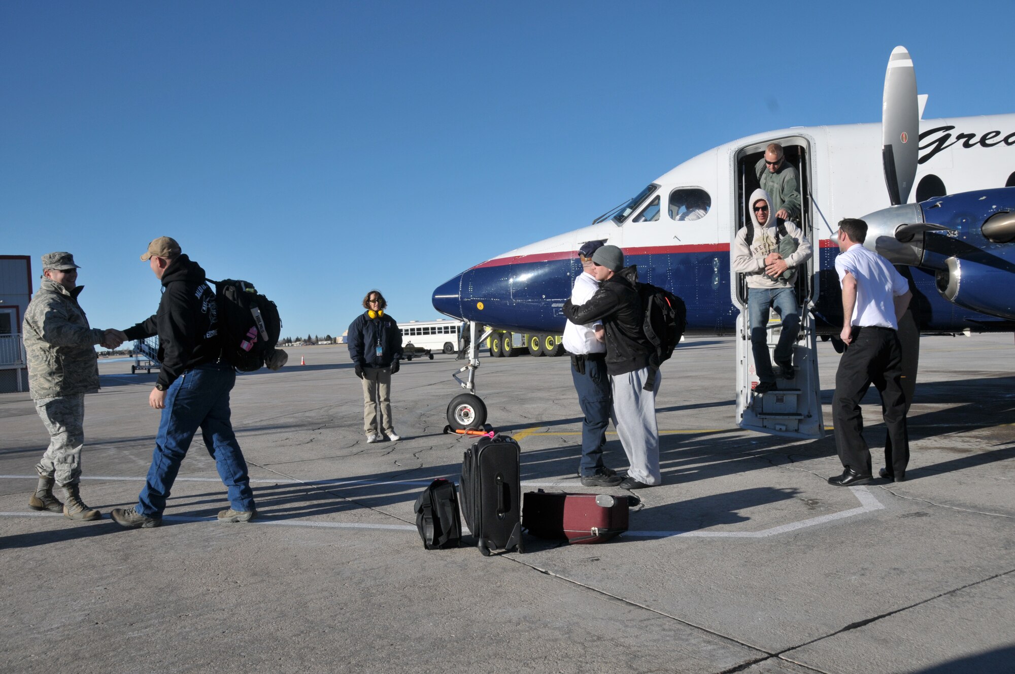 Firefighters from the 153rd Civil Engineer Squadron welcome home 11 of their fellow firefighters from a 120-day deployment to Balad Air Base, Iraq on Jan. 21, 2011. The firefighters are all members of the 153 CES, Wyoming Air National Guard, Cheyenne, Wyo. (U.S. Air Force photo by Master Sgt. Paul Mann)(Released)