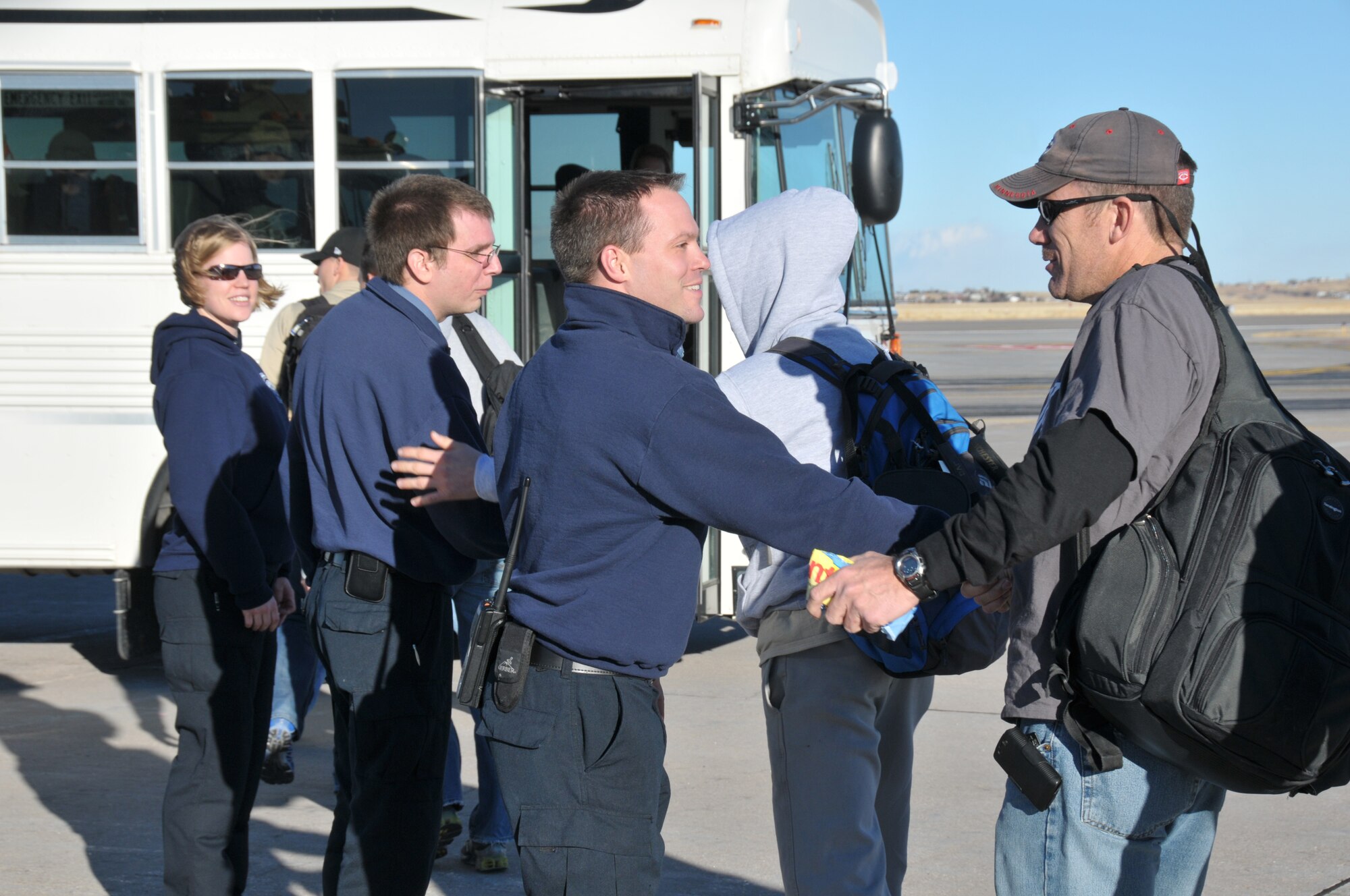 Firefighters from the 153rd Civil Engineer Squadron welcome home 11 of their fellow firefighters from a 120-day deployment to Balad Air Base, Iraq on Jan. 21, 2011. The firefighters are all members of the 153 CES, Wyoming Air National Guard, Cheyenne, Wyo. (U.S. Air Force photo by Master Sgt. Paul Mann)(Released)