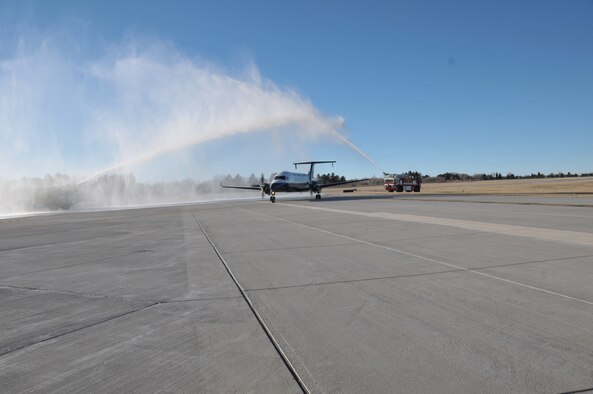 A Great Lakes Aviation aircraft taxis through a water arch, supplied by fire trucks from the 153rd Civil Engineer Squadron, Wyoming Air National Guard, Cheyenne, Wyo. The commercial aircraft is carrying 11 members of the 153 CES home from a 120-day deployment to Balad Air Base, Iraq and was given a special home coming via their fellow firefighters who protect and serve the Wyoming Air National Guard base and the Cheyenne Regional Airport. (U.S. Air Force photo by Master Sgt. Paul Mann)(Released)