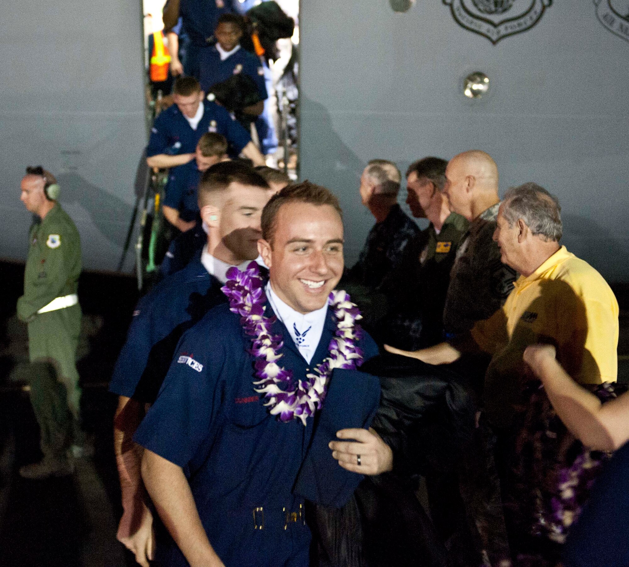 Members of Tops in Blue receive traditional Hawai'ian leis after being greeted by Joint Base Pearl Harbor-Hickam and 15th Wing leaders upon their arrival at the 15th Wing Jan. 24. Tops In Blue is an all-active duty Air Force special unit made up of talented amateur performers selected for their individual entertainment abilities. (U.S. Air Force photo by Staff Sgt. Nathan Allen)