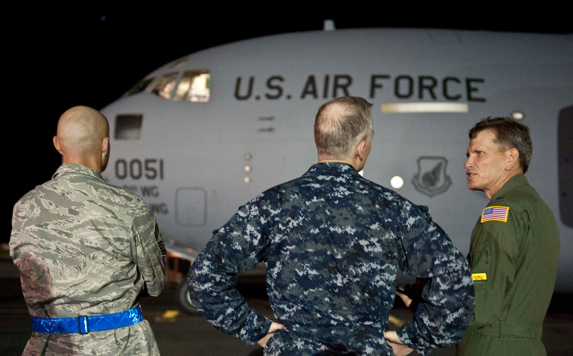 (From left) Chief Master Sgt. Craig Recker, 15th Wing command chief, U.S. Navy Capt. Richard Kitchens, Joint Base Pearl Harbor-Hickam commander, and Col. Joe Dague, 15th Wing vice commander, prepare to greet members of Tops in Blue upon their arrival at the 15th Wing Jan. 24. Tops In Blue is an all-active duty Air Force special unit made up of talented amateur performers selected for their individual entertainment abilities. (U.S. Air Force photo by Staff Sgt. Nathan Allen)