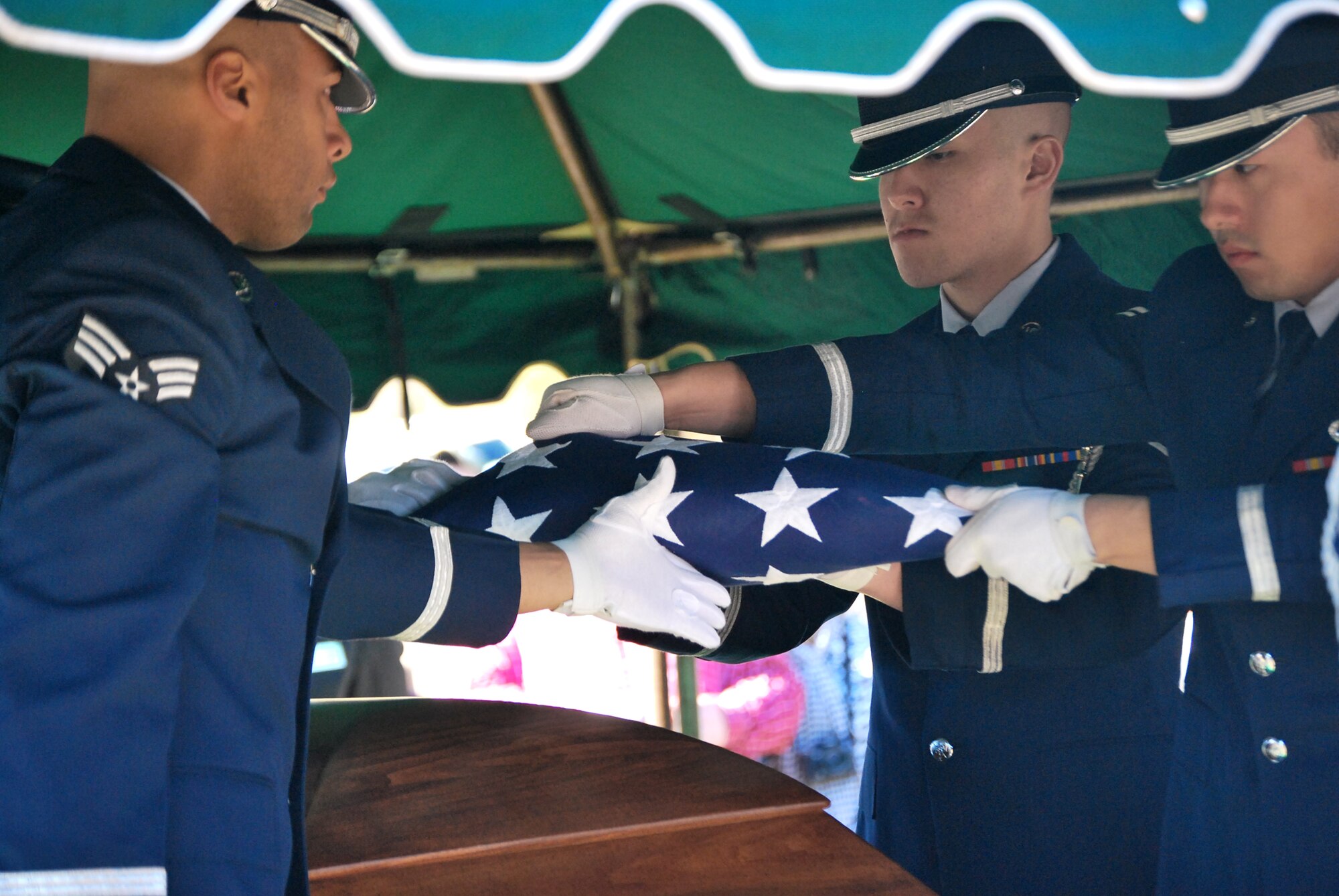 Airmen from the Eglin Air Force Base, Fla., Honor Guard fold the flag that covered the coffin of 1st Lt. Robert Franklin Dees during his funeral Jan. 22, 2011, in Ozark, Ala. The flag was presented to Linda K. Dees, the niece of the fallen Airman. (U.S. Air Force photo/Van Williams)