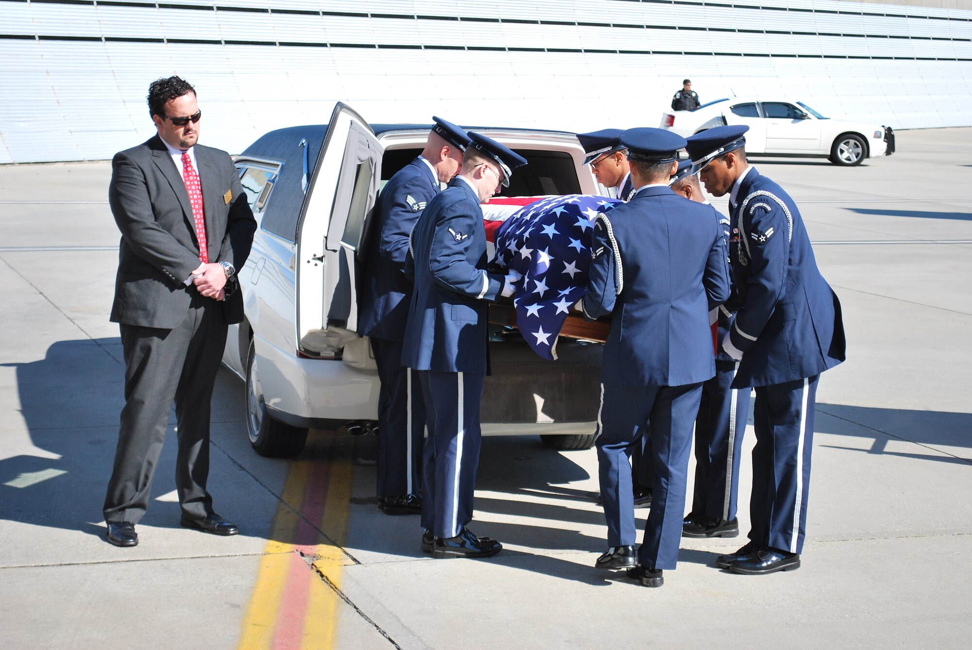 Airmen from the Eglin Air Force Base, Fla., Honor Guard place the coffin of 1st Lt. Robert Franklin Dees in to a waiting hearse Jan. 21, 2011, at Pensacola Regional Airport, Fla. Lieutenant Dees was missing since the Korean War and was being returned home to Ozark, Ala., for burial. (U.S. Air Force photo/Van Williams) 