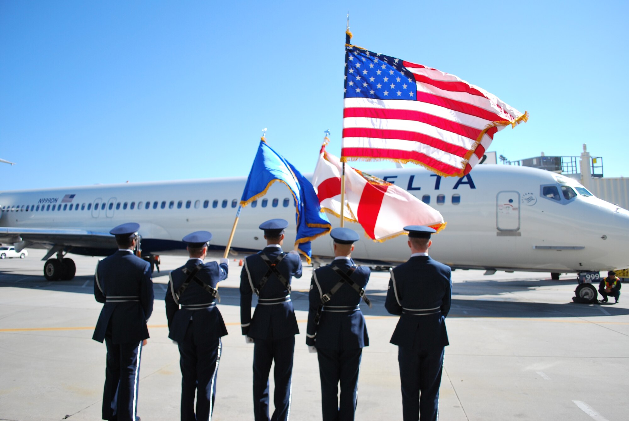 Airmen from the Eglin Air Force Base, Fla., Honor Guard render honors Jan. 21, 2011, as the plane carrying the remains of 1st Lt. Robert Franklin Dees arrives at the Pensacola Regional Airport, Fla. Lieutenant Dees was missing since the Korean War and was being returned home to Ozark, Ala., for burial. (U.S. Air Force photo/Van Williams) 