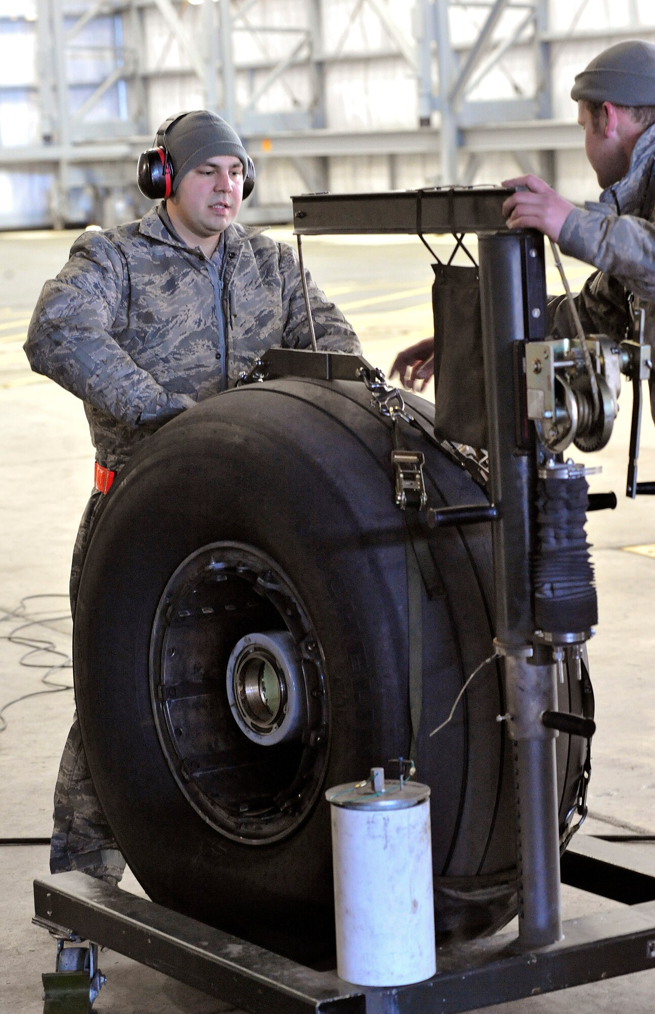 Airman Banks gets ready to support the weight of a C-17 Globemaster III tire Jan. 24, 2011. (U.S. Air Force photo/Airman 1st Class Jacob Morgan)